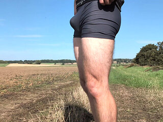 Stripping naked on a footpath next to a field