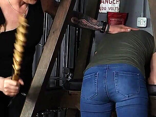 Slave Mila's Feet Dangle and Quiver as Mistress Baton Breaks in Heavy Wooden Paddle Over Her Jeans and Bare