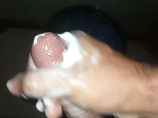 Guy in the shower soaps and masturbates by taking milk out of penis