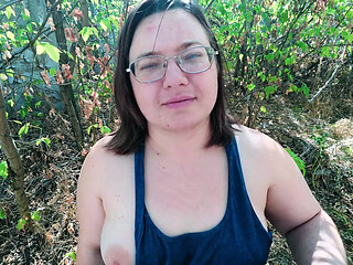 Chubby glasses girl shows off big tits in abandoned house