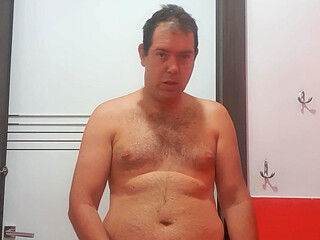 A boy completely naked in a station bathroom