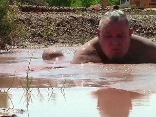Deep, Creamy Brown Mud Bath in a Sand Pit