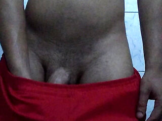Skinny young guy masturbating big thick cock in red shorts