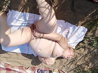 Squirting from masturbation on a common beach