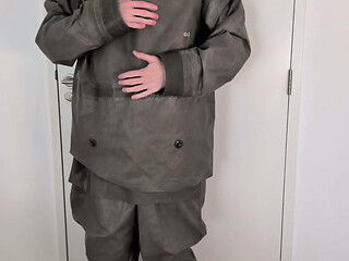 Putting on Zodiac Zodiak heavy rubber hazmat suit over plastic pants and gas mask