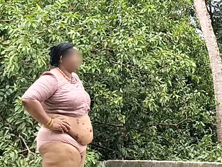 A full-figured woman in a white skirt and pink top strips down and walks nude outside.