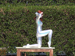 Bending in a Silver Spandex Suit