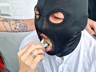 Brunette Dominatrix Nika smokes cigarette on balcony and uses slave man as her ashtray