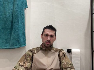 Military guy two hands jerks his meat