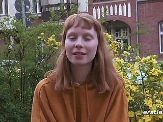 Sexy redhead amateur babe plays with her untrimmed bush.