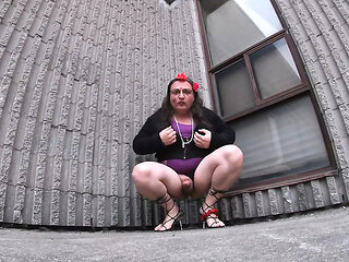 Older Mature CD is a sissy exposing her ass in a vacant lot.