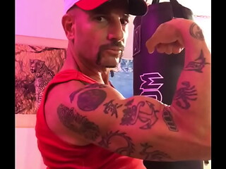 BICEP FLEXING STRONG ARM WITH TATTOOS
