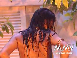 Hot brunette posing wet outdoors