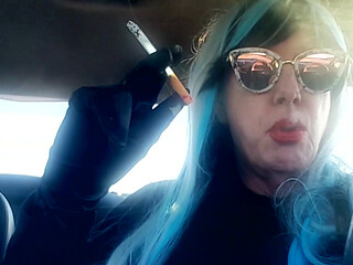 MATURE CD SMOKING & DRIVING WITH A MB100 CIGARETTE IN HER GLOVED HAND