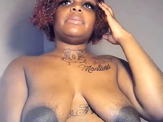 Black milf with large saggy breasts showing off her huge perky nipples