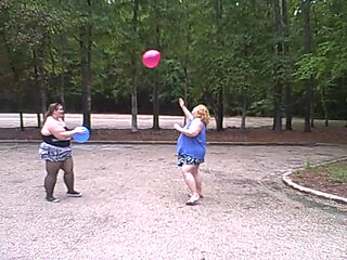 BBW gals play volley ball with balloons
