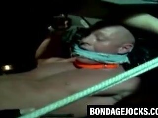 Jock bound with fat rope in outdoor BDSM scene