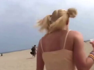 Petite teen masturbating on the beach