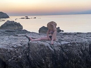 Sultry milf masturbates on a public beach, wet pussy on full display