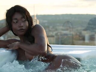 Petite Ebony MILF strips naked in a pool