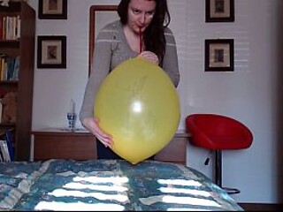 Curvy solo MILF Nicoletta plays with yellow balloons in a latex outfit