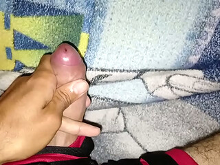 Young man masturbates his big, tasty cock while wearing shorts