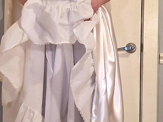 Trying on a liquid satin wedding dress.