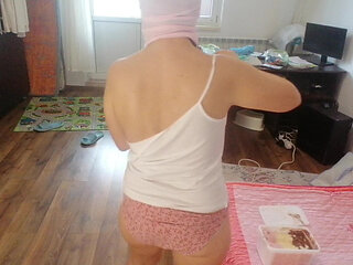 Amateur wife dancing naked at home. Amateur woman has fun trying on clothes and cutting them.