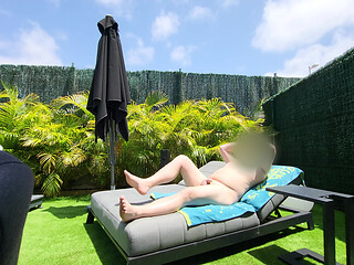 Nude guy lay on a sunlounger