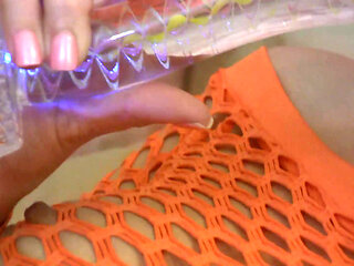 Babe in fishnet outfit rips pantyhose and puts a dildo in her shaved cunt