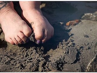 Feet In The Sand At The Beach