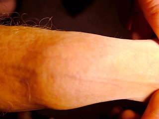 Very Close up on the tip of his uncut penis as he plays with his foreskin and show bell-end