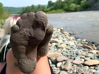 Goddess shows you her messy nylon feet close ups in torn pantyhose on the river bank