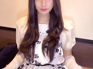 A video of a curly-haired crossdresser quietly masturbating.