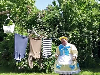 In an outfit with a yellow and blue maid dress to hang the laundry.