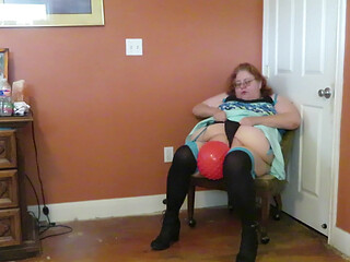 Nurse Vicki  plays with a rubber ball in a mini skirt, sexy stockings and high heel mini boots