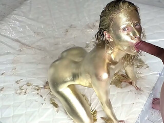 Pretty woman makes herself a golden body art, then gently fucks and sucks a dick, filled the whole body art with sperm