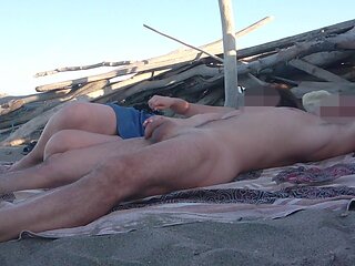 Exhibitionist wife Miss Creamy gives a handjob to a big cock on a nude beach in front of strangers