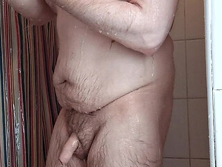 Chubby Uncut Showers with porn in background
