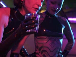 Mistress Ae dominates with strap-on in latex, Eva Elfie assists