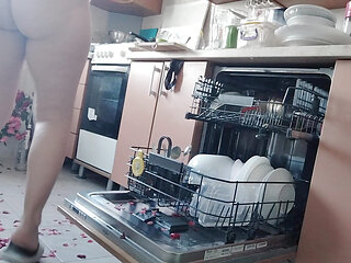 Sexy naked woman preparing food in the kitchen. Hairy brown hair, big ass, big.