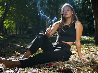 Seductive Russian Beauty Smoking Cigarette in Studio