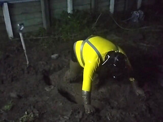 Latex Biohazard Drone Plays in Mud Pit