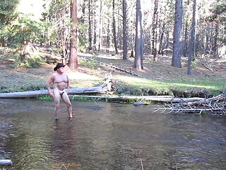 Bathing naked in the creek.