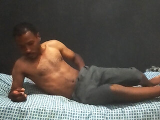 Brunette man in his bedroom masturbating