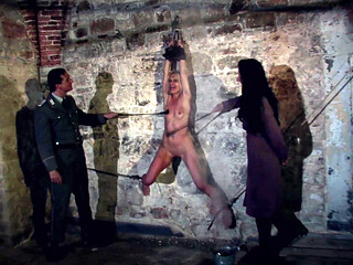 Hanging at the Wall with Her Legs Spread Wide Apart the Female Prisoner Is Made Hot by Lashes