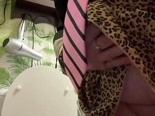 In uniform with a shirt and tie and a skirt to pee on the toilet like a good female