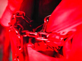 Dominant woman shoves submissive's cock in chastity cage