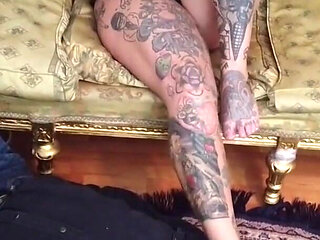 Worshiping the feet of a tattooed blonde lady