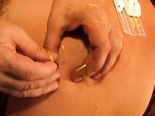 Busty Blonde MILF takes intense needle play from a dominant man.
